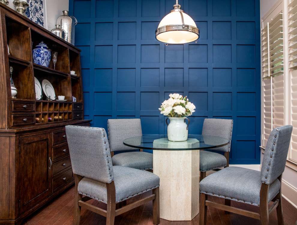 Inspiration for a medium sized country dining room in Atlanta with banquette seating, blue walls, dark hardwood flooring, brown floors and panelled walls.