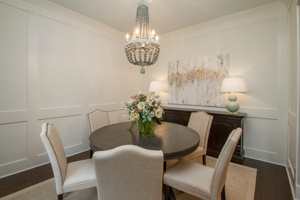 This is an example of a transitional dining room in Little Rock with white walls and dark hardwood floors.