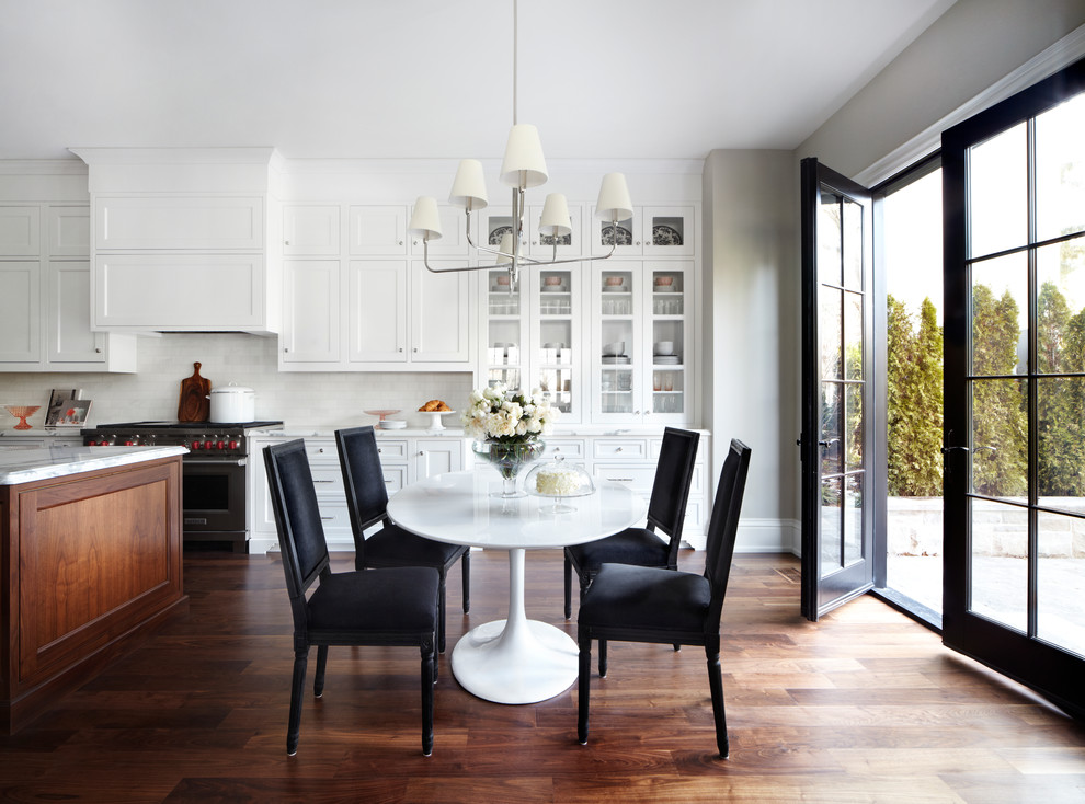 This is an example of a transitional kitchen/dining combo in Toronto with white walls and dark hardwood floors.