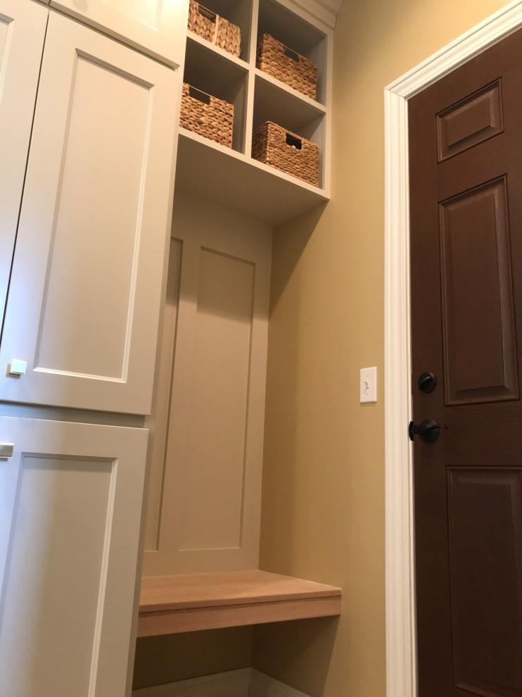 Large minimalist l-shaped light wood floor kitchen photo with an undermount sink, recessed-panel cabinets, blue cabinets, tile countertops, white backsplash, ceramic backsplash, paneled appliances, an island and white countertops