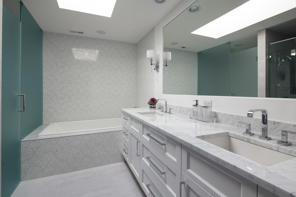 Photo of a mid-sized bathroom in Chicago with furniture-like cabinets, white cabinets, an alcove tub, an alcove shower, a two-piece toilet, gray tile, mosaic tile, white walls, porcelain floors, an undermount sink, tile benchtops, grey floor, a hinged shower door and black benchtops.
