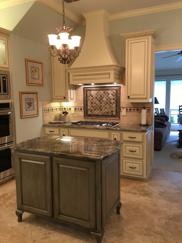 Mid-sized traditional kitchen in Dallas with raised-panel cabinets, white cabinets, marble benchtops, beige splashback, stone tile splashback, ceramic floors and with island.