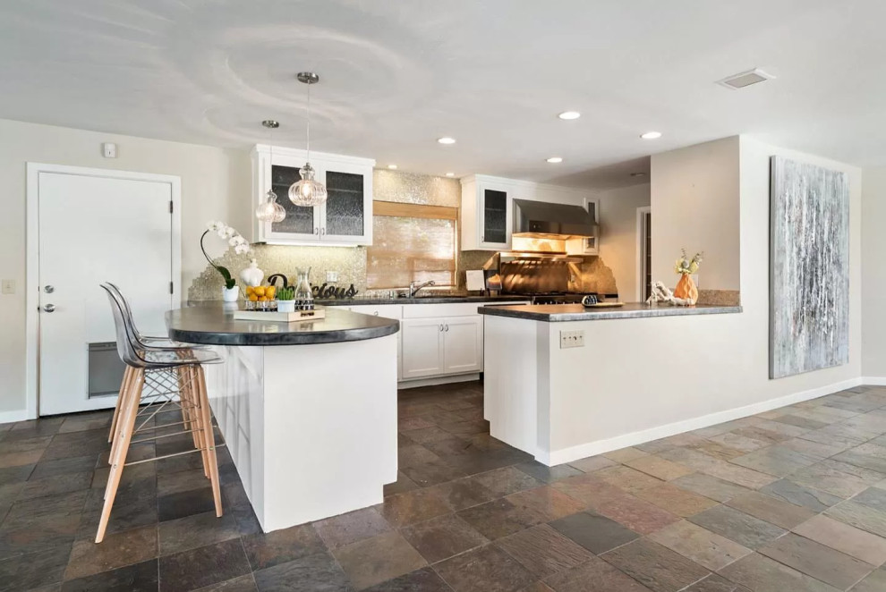 Mid-sized contemporary u-shaped kitchen in San Francisco with an undermount sink, shaker cabinets, white cabinets, concrete benchtops, multi-coloured splashback, mosaic tile splashback, stainless steel appliances, slate floors, multi-coloured floor and grey benchtop.