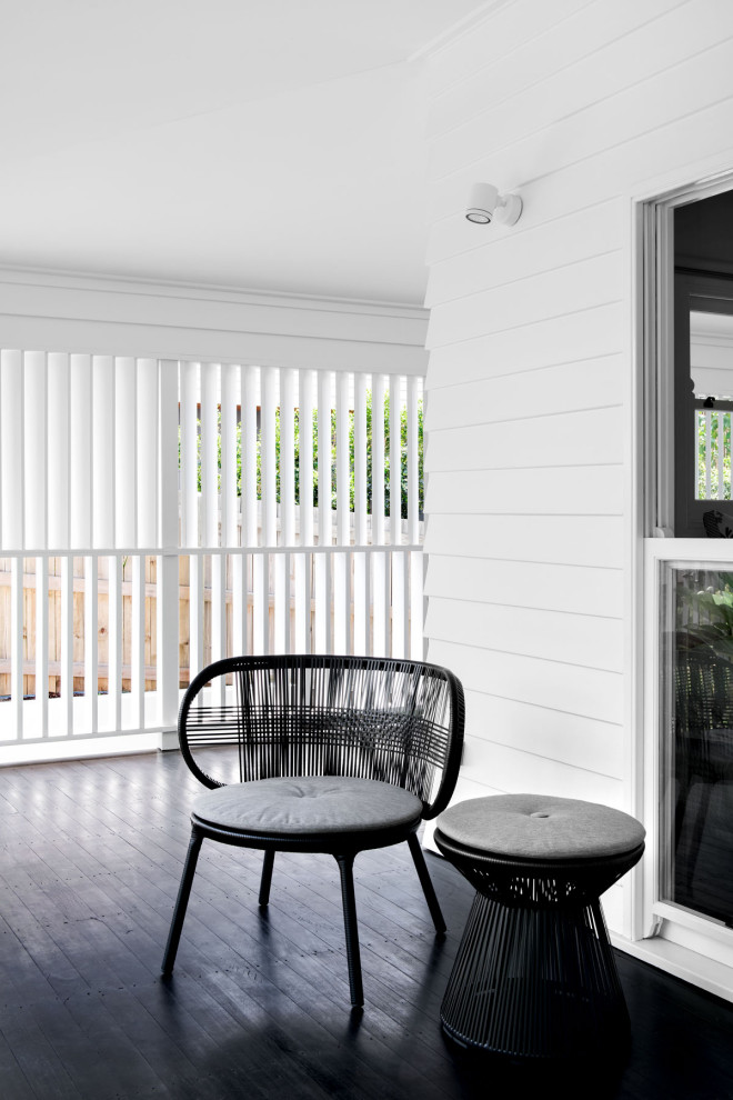 Design ideas for a large traditional front yard screened-in verandah in Brisbane with decking and a roof extension.