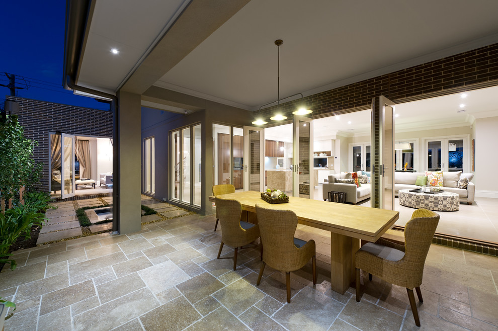 This is an example of a transitional patio in Melbourne with a roof extension.