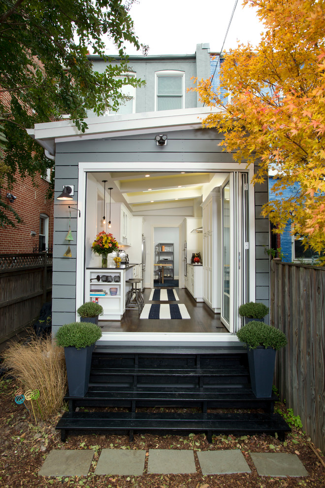 Mid-sized transitional two-storey grey exterior in DC Metro with wood siding and a shed roof.