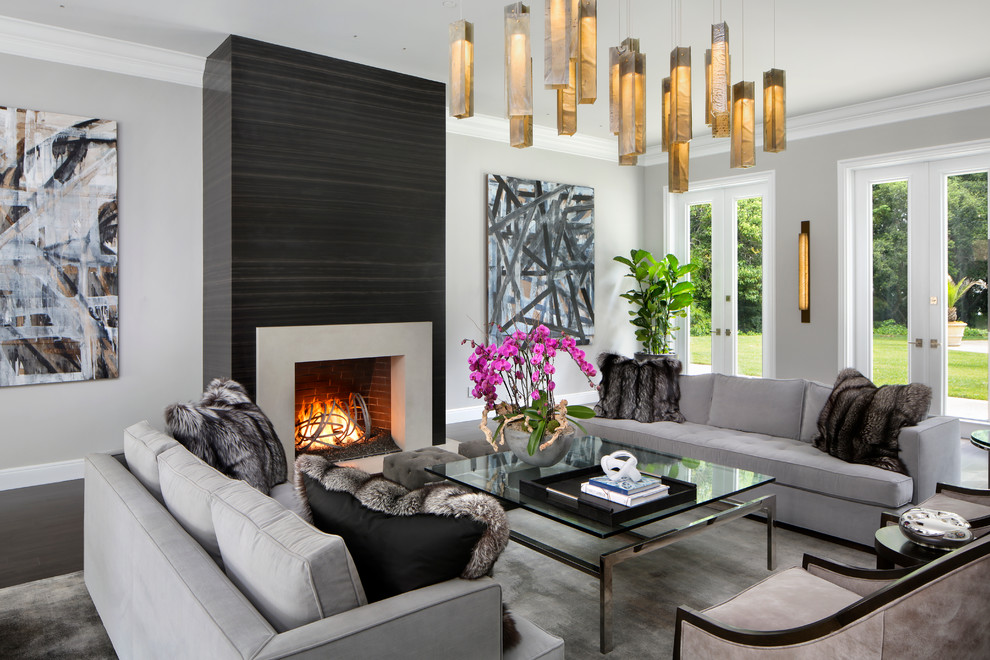 This is an example of a mid-sized contemporary formal open concept living room in San Francisco with grey walls, dark hardwood floors, a standard fireplace, a stone fireplace surround, no tv and brown floor.