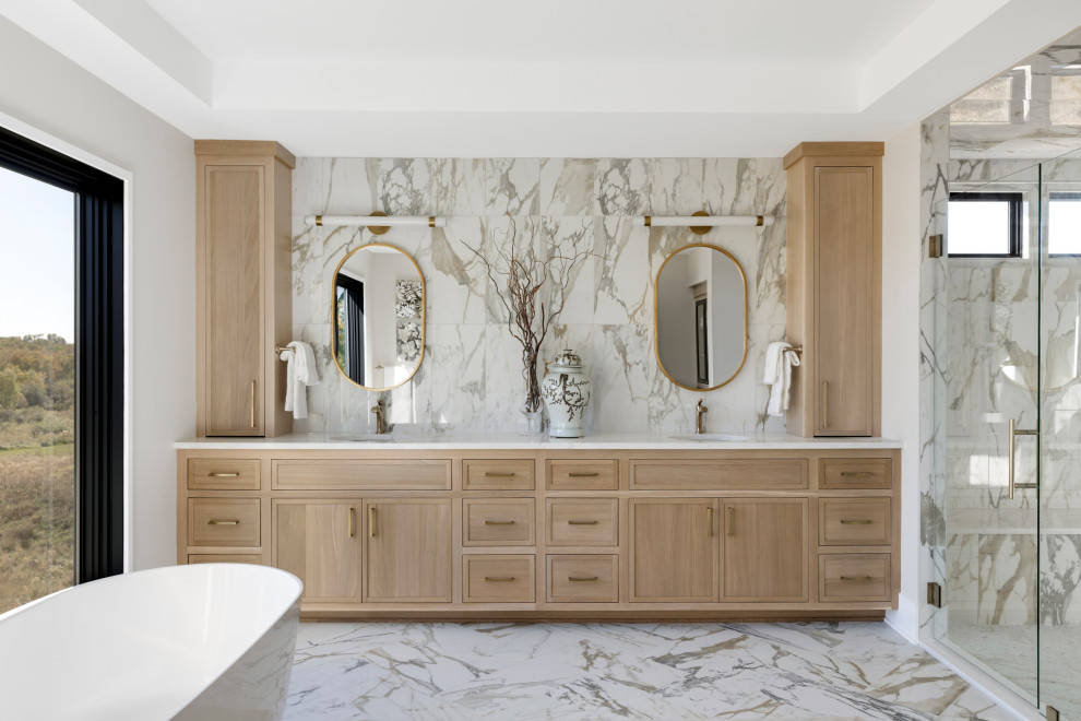 Example of a huge transitional master multicolored tile and ceramic tile ceramic tile, multicolored floor and double-sink bathroom design in Minneapolis with flat-panel cabinets, light wood cabinets, gray walls, an undermount sink, quartz countertops, a hinged shower door, white countertops and a built-in vanity