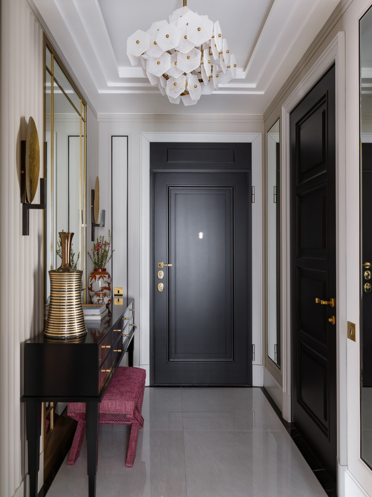 Свежая идея для дизайна: входная дверь в стиле неоклассика (современная классика) с белыми стенами, одностворчатой входной дверью, черной входной дверью и серым полом - отличное фото интерьера