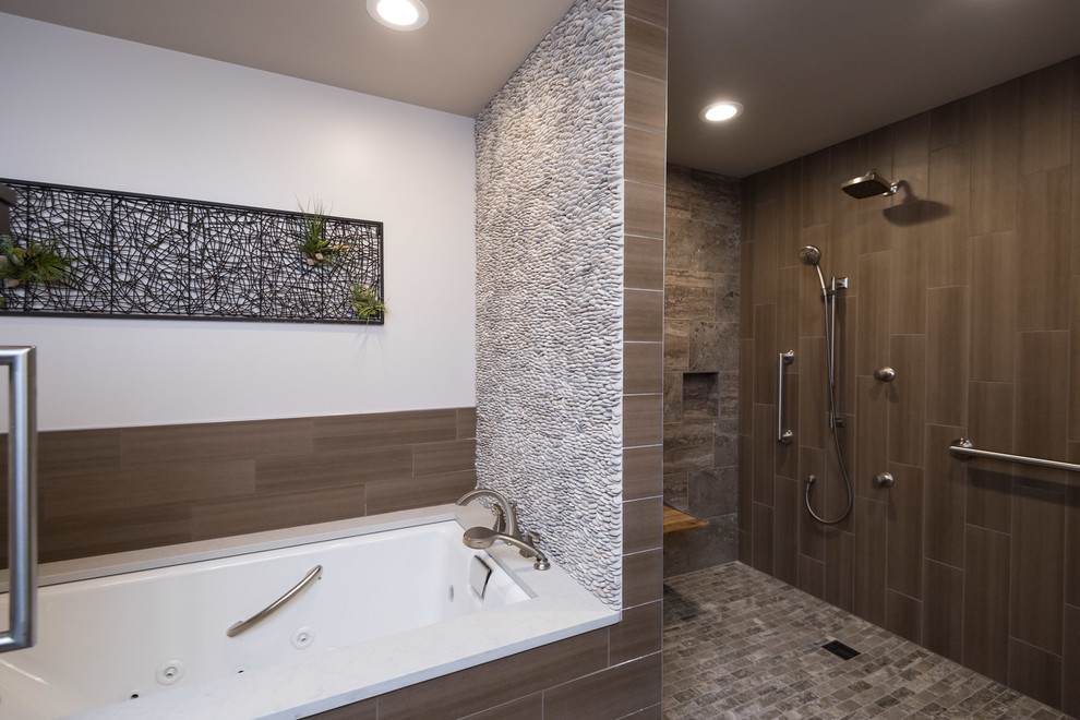 Photo of a mid-sized modern master wet room bathroom in St Louis with shaker cabinets, dark wood cabinets, an alcove tub, brown tile, an undermount sink and quartzite benchtops.