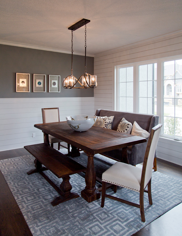 This is an example of a mid-sized country separate dining room in Kansas City with grey walls, dark hardwood floors and brown floor.