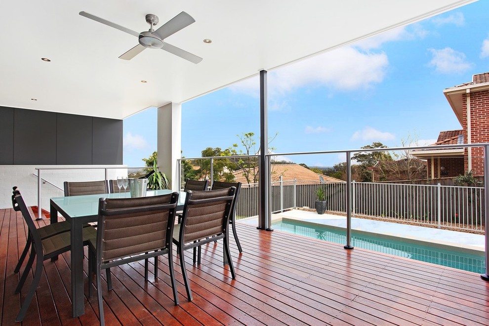 This is an example of a large contemporary backyard deck in Newcastle - Maitland with a roof extension.