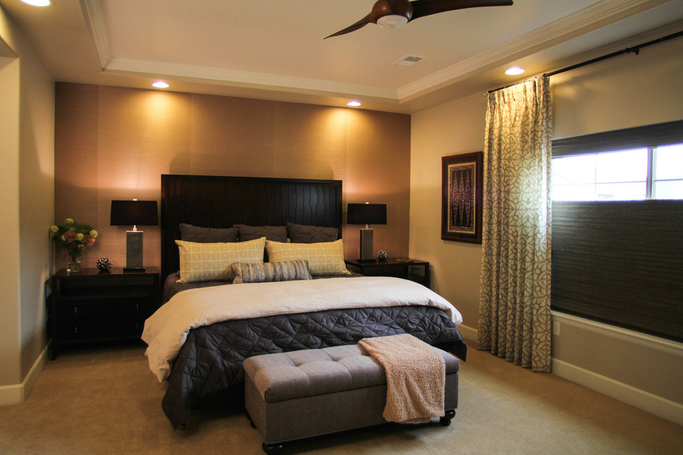 This is an example of a large transitional master bedroom in Denver with beige walls and carpet.