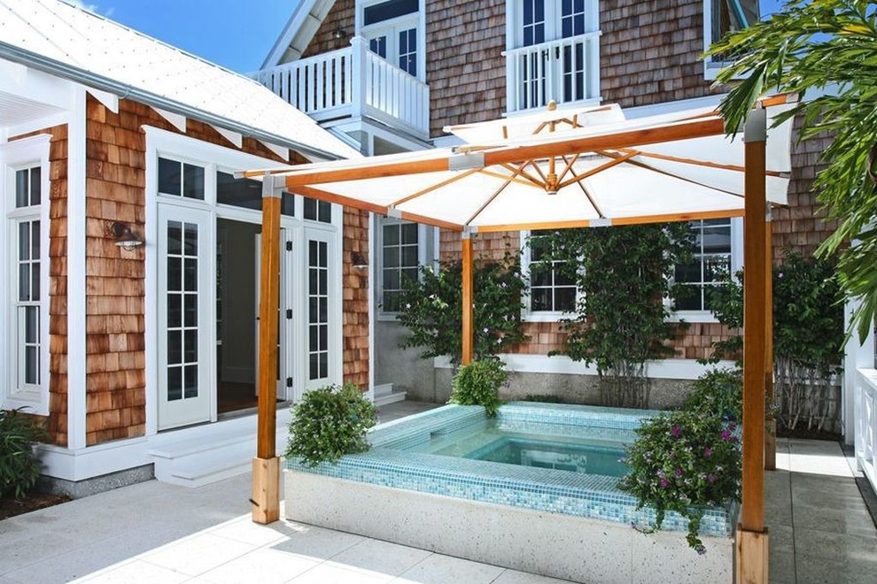 Inspiration for a small traditional rectangular pool in Miami with a hot tub and tile.