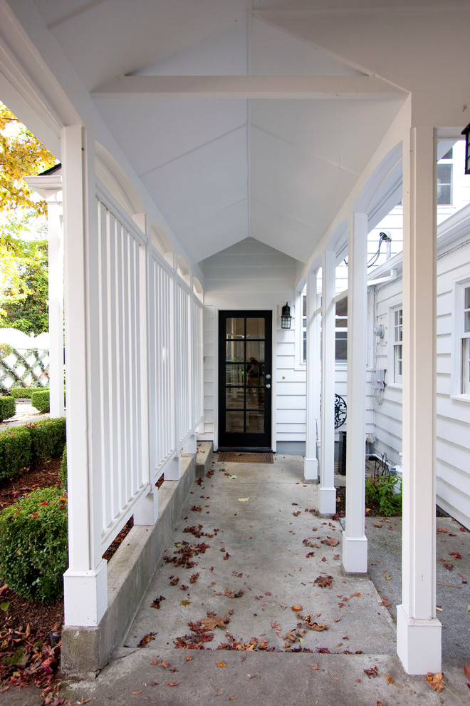 Design ideas for a traditional entryway in Portland with white walls, a single front door and a glass front door.