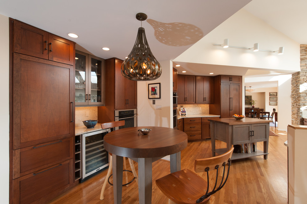 Example of a large transitional kitchen design in DC Metro with an undermount sink, shaker cabinets, granite countertops, stainless steel appliances and an island