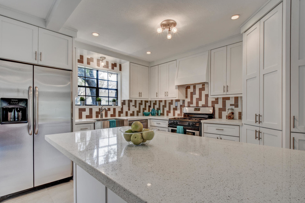 Example of a mid-sized transitional l-shaped porcelain tile and white floor kitchen design in Austin with a farmhouse sink, shaker cabinets, white cabinets, quartz countertops, multicolored backsplash, ceramic backsplash, stainless steel appliances, a peninsula and white countertops