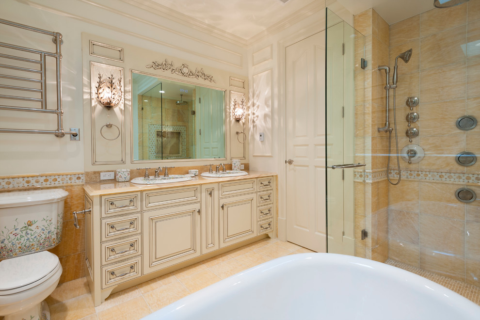 Design ideas for a traditional master bathroom in Vancouver with a drop-in sink, raised-panel cabinets, distressed cabinets, onyx benchtops, a claw-foot tub, a corner shower, a two-piece toilet, stone tile, white walls, marble floors and orange tile.