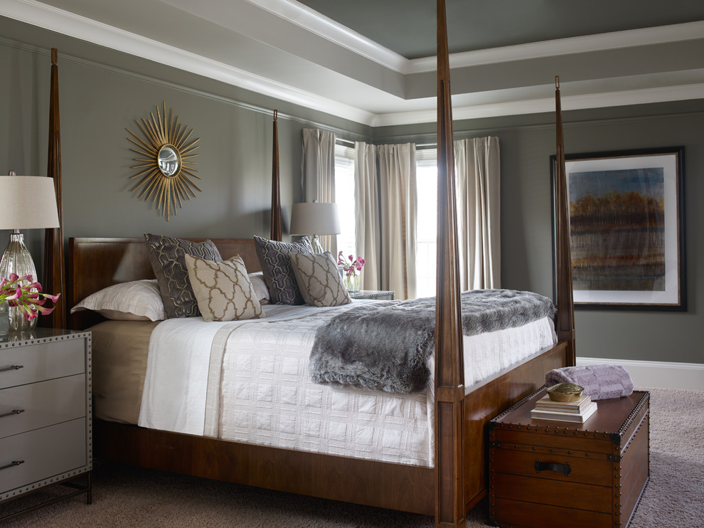 This is an example of a large transitional master bedroom in Atlanta with carpet and grey walls.