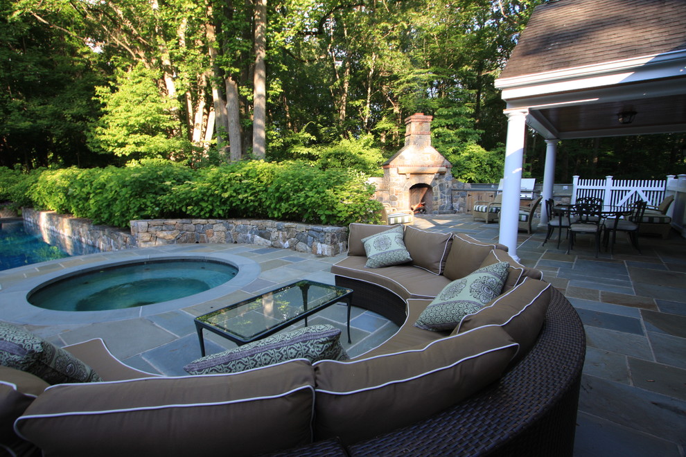 Photo of a contemporary backyard patio in New York with natural stone pavers.