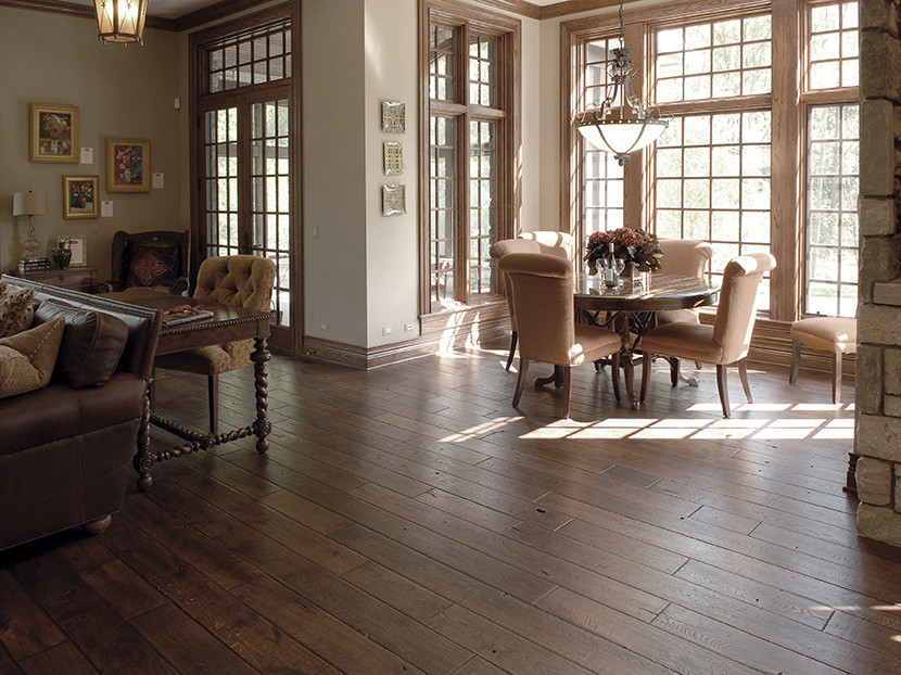 Design ideas for a large traditional dining room in Chicago with white walls, dark hardwood floors and brown floor.