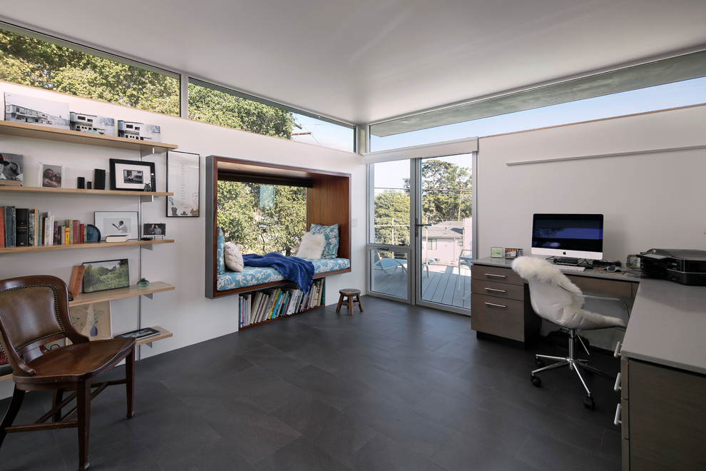 Mid-sized contemporary home office in Santa Barbara with white walls, porcelain floors, no fireplace and grey floor.