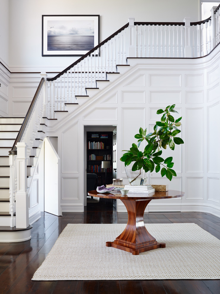 Inspiration for a large traditional foyer in Jacksonville with white walls and dark hardwood floors.