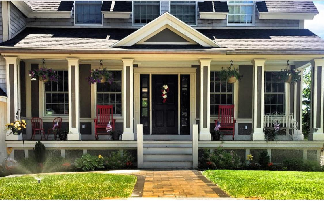 Example of a mid-sized classic gray two-story wood exterior home design in Boston with a shingle roof