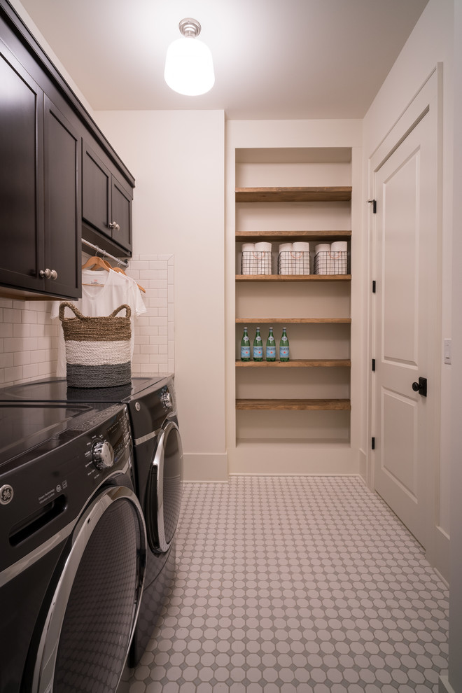 Design ideas for a transitional utility room in Charlotte with recessed-panel cabinets, dark wood cabinets, grey walls and a side-by-side washer and dryer.