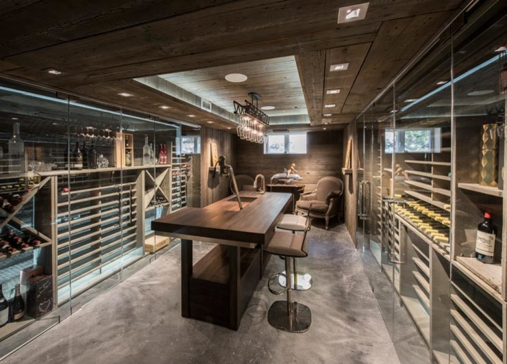 Mid-sized contemporary wine cellar in Ottawa with concrete floors and storage racks.
