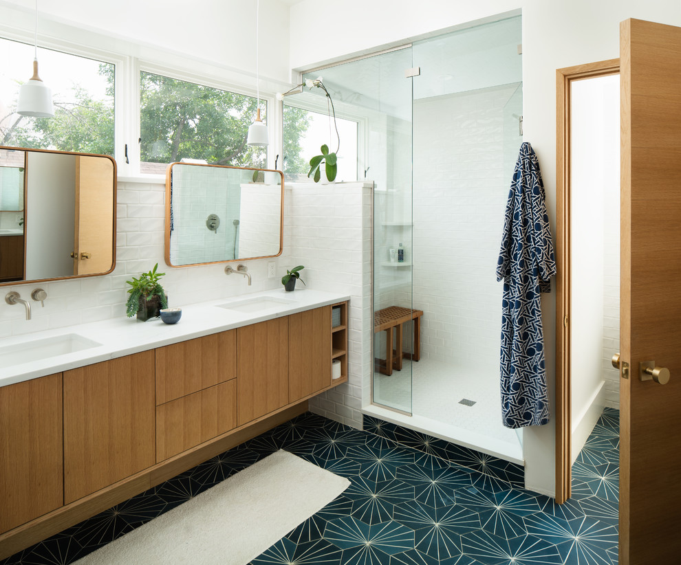 This is an example of a midcentury master bathroom in Denver with flat-panel cabinets, light wood cabinets, an alcove shower, white tile, subway tile, white walls, an undermount sink, green floor, a hinged shower door and white benchtops.