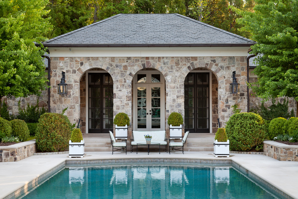 This is an example of a traditional rectangular pool in Atlanta with a pool house.