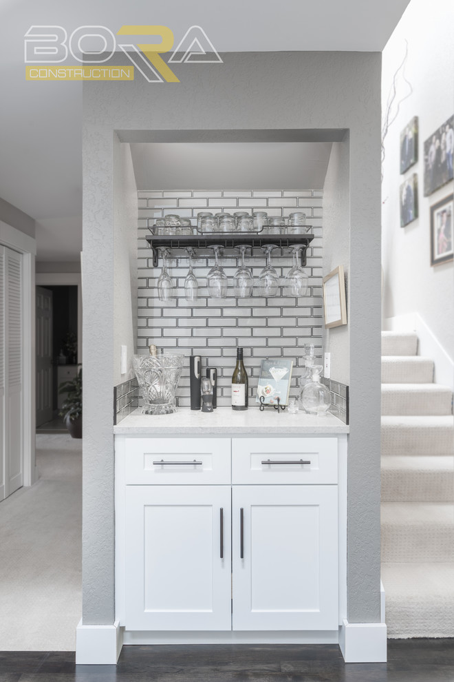Inspiration for a mid-sized transitional u-shaped dark wood floor and brown floor eat-in kitchen remodel with an undermount sink, recessed-panel cabinets, white cabinets, wood countertops, metallic backsplash, ceramic backsplash, stainless steel appliances and a peninsula