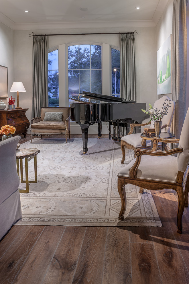 Inspiration for a mid-sized traditional enclosed family room in Houston with a music area, grey walls, medium hardwood floors, no fireplace and no tv.