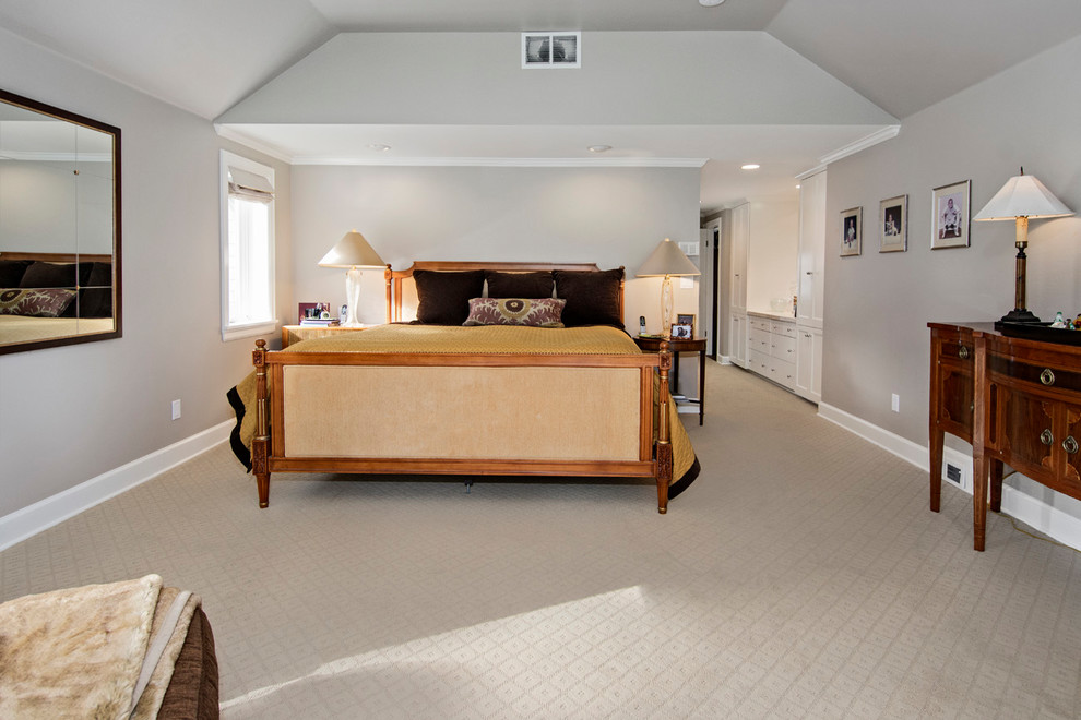 This is an example of a large traditional master bedroom in Seattle with beige walls, carpet, no fireplace and beige floor.
