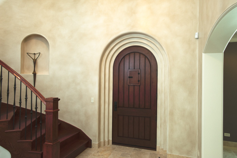 Inspiration for a large mediterranean front door in Chicago with a single front door and a dark wood front door.