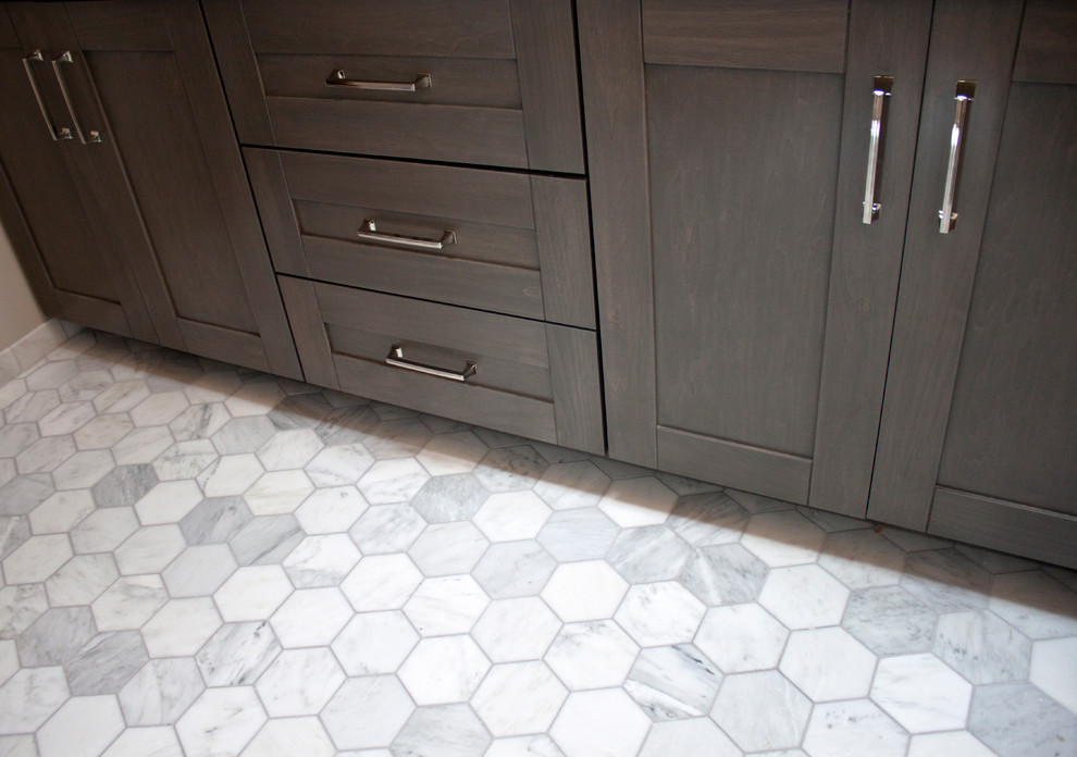 Mid-sized transitional master gray tile and marble tile marble floor and gray floor home design photo in Chicago with shaker cabinets, dark wood cabinets, a one-piece toilet, gray walls, an undermount sink, granite countertops and a hinged shower door