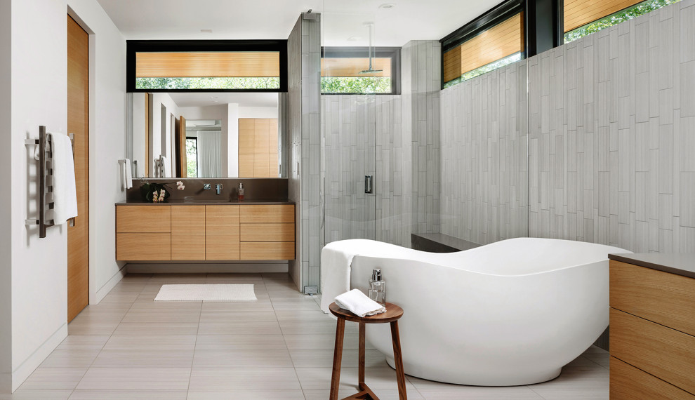 Inspiration for a contemporary master bathroom in Austin with flat-panel cabinets, light wood cabinets, a freestanding tub, an alcove shower, gray tile, white walls, an undermount sink, a hinged shower door, brown benchtops and a floating vanity.