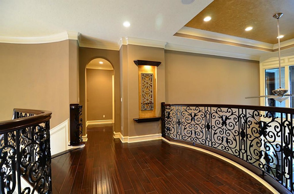 This is an example of a large traditional wood curved staircase in Dallas with mixed railing.