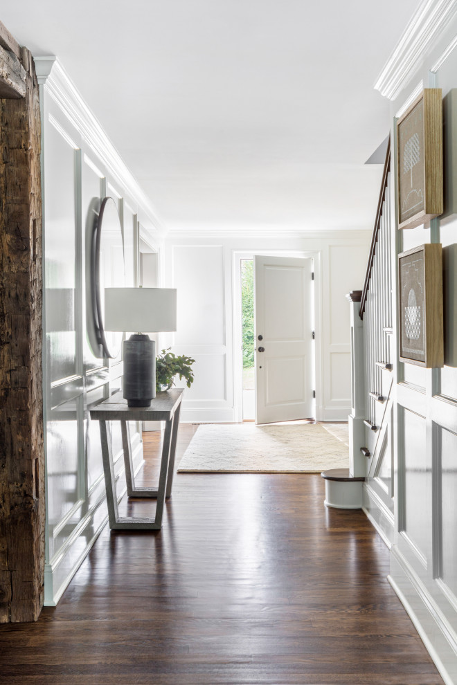 Design ideas for a large contemporary foyer in New York with dark hardwood floors, a single front door, a white front door, brown floor and white walls.