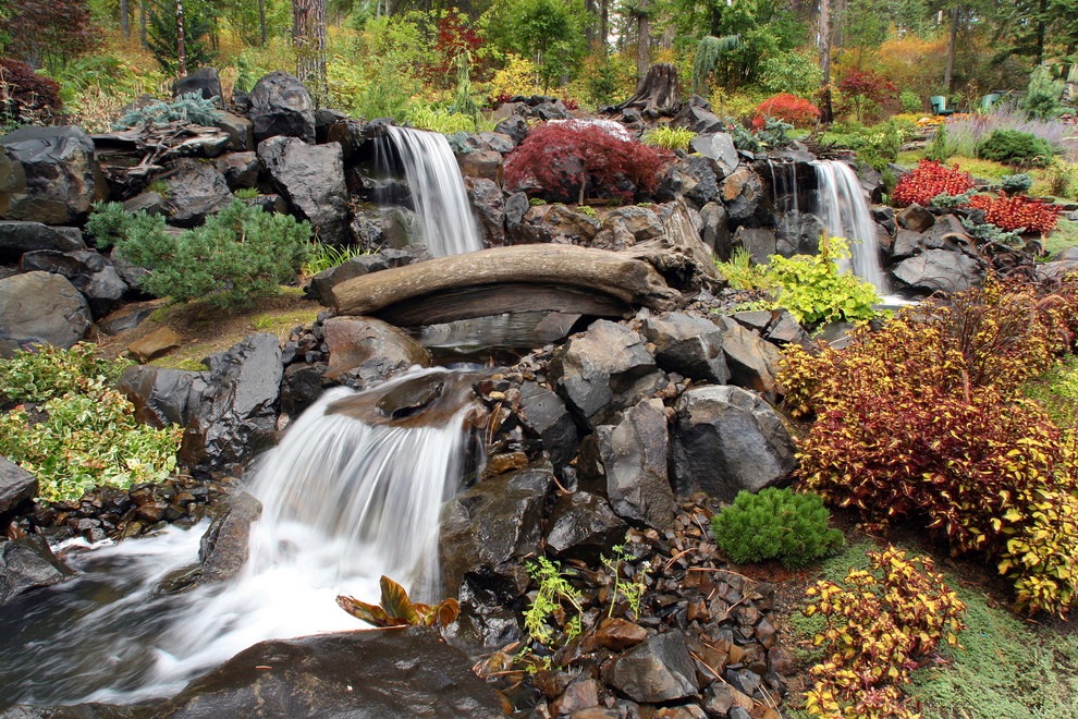 Inspiration for an eclectic garden in Seattle with with waterfall.