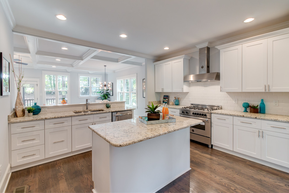 Photo of a large arts and crafts l-shaped eat-in kitchen in Raleigh with an undermount sink, shaker cabinets, white cabinets, granite benchtops, white splashback, subway tile splashback, stainless steel appliances, dark hardwood floors and with island.