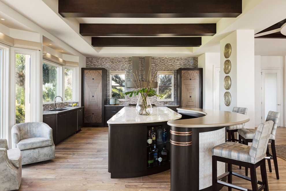 Design ideas for a large transitional kitchen in Miami with flat-panel cabinets, dark wood cabinets, onyx benchtops, a single-bowl sink, multi-coloured splashback, mosaic tile splashback, light hardwood floors and multiple islands.