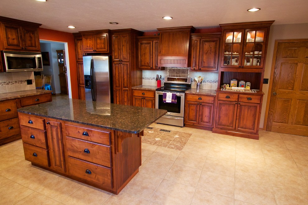 Open concept kitchen - large u-shaped open concept kitchen idea with a drop-in sink, raised-panel cabinets, medium tone wood cabinets, beige backsplash, ceramic backsplash, stainless steel appliances and an island