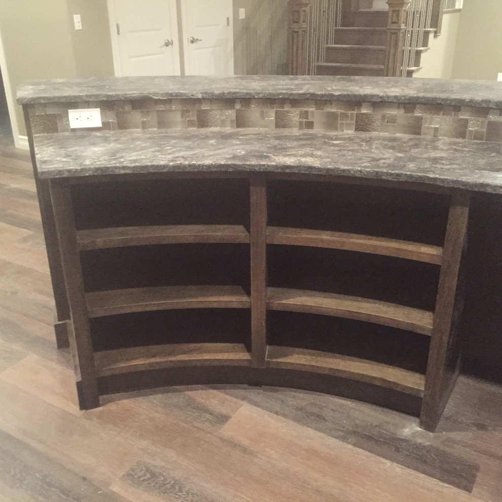 Wet bar - mid-sized rustic u-shaped vinyl floor wet bar idea in Calgary with an undermount sink, raised-panel cabinets, dark wood cabinets and granite countertops