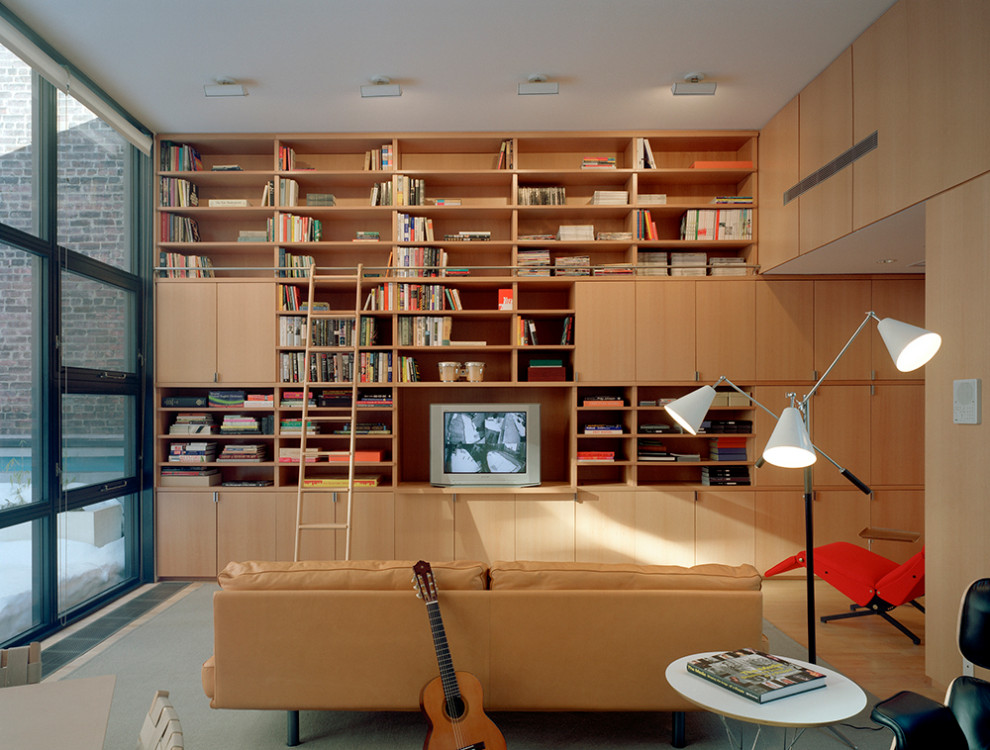 ニューヨークにあるラグジュアリーな広いミッドセンチュリースタイルのおしゃれなホームオフィス・書斎 (ライブラリー、茶色い壁、カーペット敷き、グレーの床、板張り壁) の写真