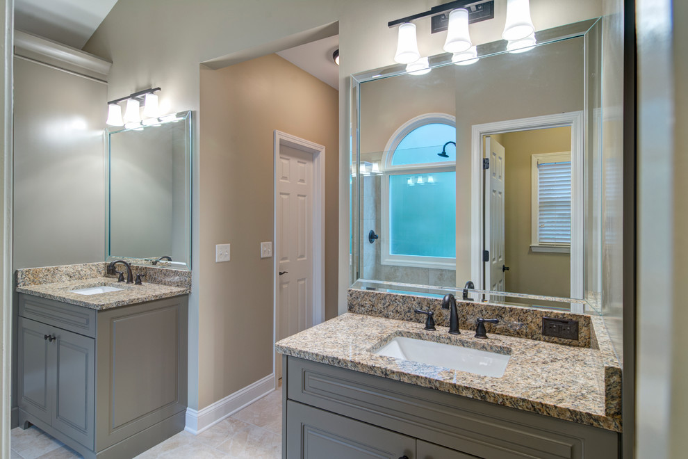 Photo of a mid-sized traditional master bathroom in Atlanta with raised-panel cabinets, grey cabinets, a corner shower, a one-piece toilet, beige tile, stone tile, beige walls, porcelain floors, an undermount sink and granite benchtops.