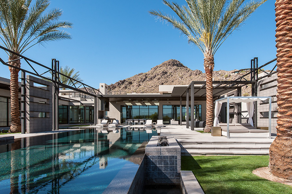 Design ideas for a contemporary backyard rectangular infinity pool in Phoenix.