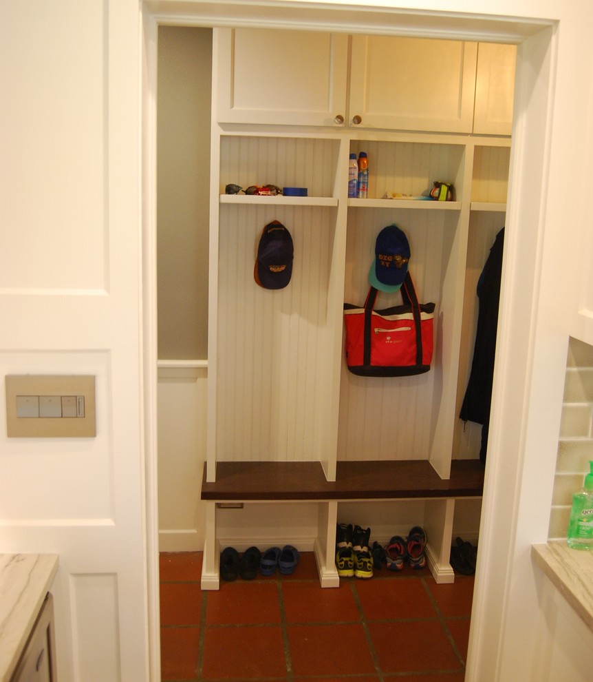 Inspiration for a mid-sized transitional u-shaped light wood floor kitchen remodel in Austin with a farmhouse sink, shaker cabinets, white cabinets, quartzite countertops, beige backsplash, porcelain backsplash, stainless steel appliances and an island