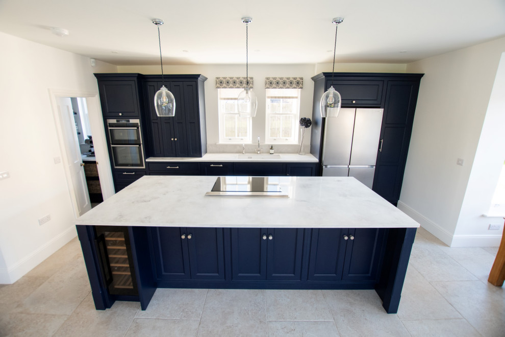 Inspiration for a medium sized urban galley kitchen/diner in Cambridgeshire with an integrated sink, shaker cabinets, blue cabinets, quartz worktops, stainless steel appliances, limestone flooring, an island, grey floors and grey worktops.